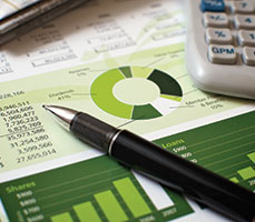 Photo of numbers and charts on paper. Links to Donor-Advised Fund