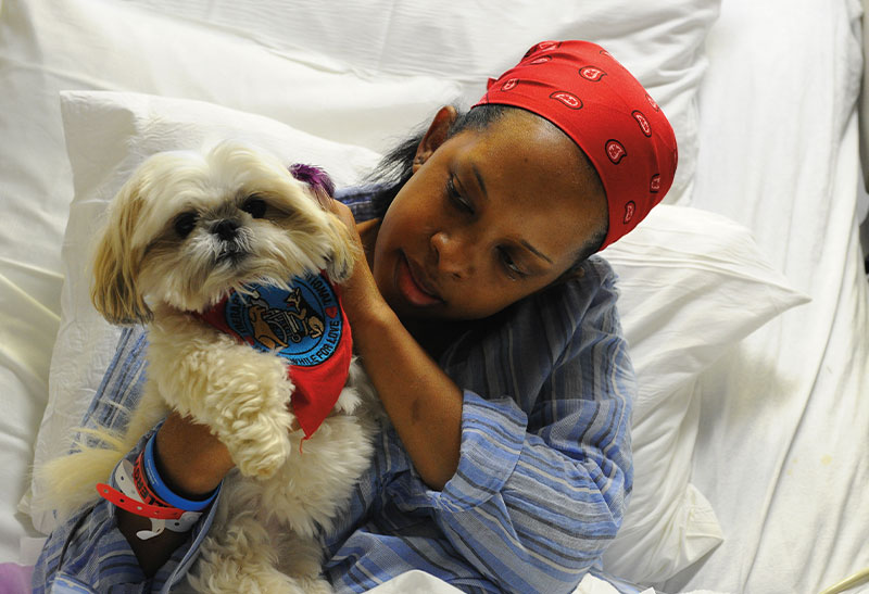 Photo of a patient and a dog