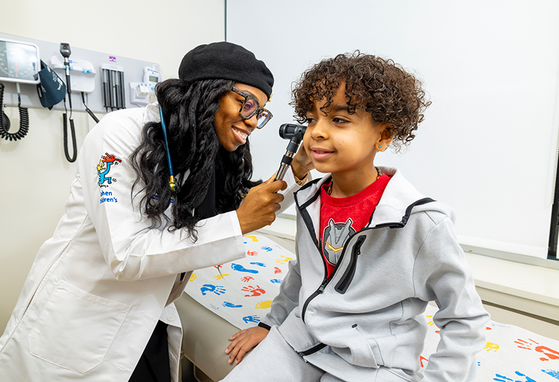 Photo of two staff and a patient